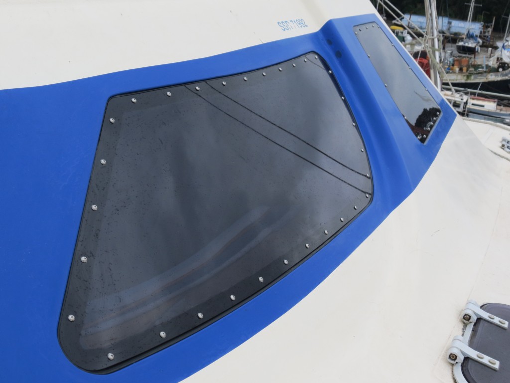 New acrylic windows bonded and screwed to an ocean going catamaran