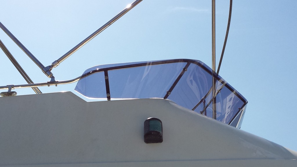 Trader replacement screen - This is a replacement flybridge screen made using grey tinted acrylic. We have shaped and formed it to fit the existing frame work on the flybridge.